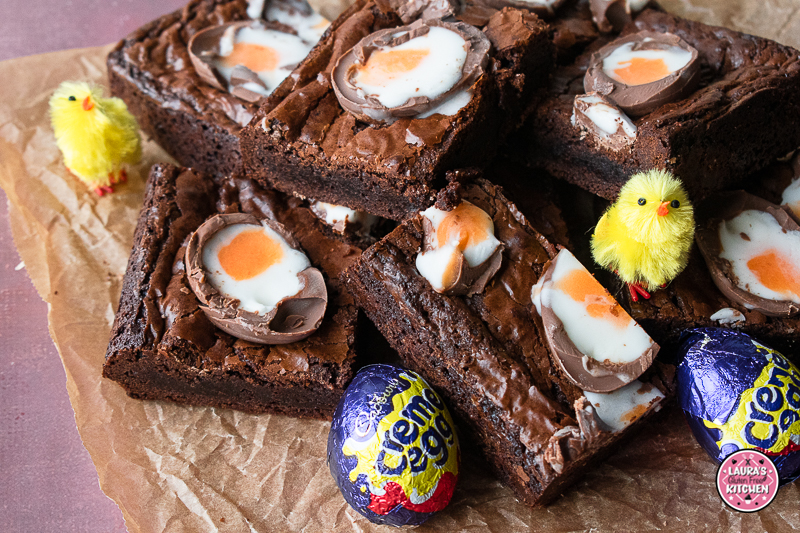 Close up of gluten-free creme egg brownies topped with halved Cadbury Creme Eggs