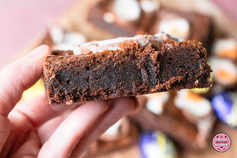 Slice of fudgy gluten-free brownie with melted creme egg centre