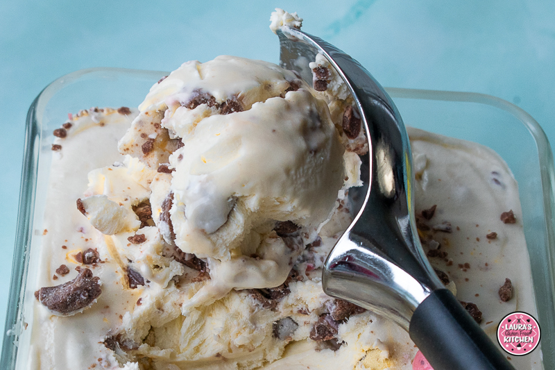 Scoops of mini egg ice cream with crushed Cadbury Mini Eggs in a bowl.