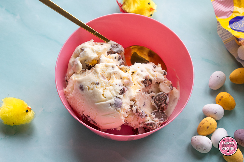 Scoops of mini egg ice cream with crushed Cadbury Mini Eggs in a bowl.